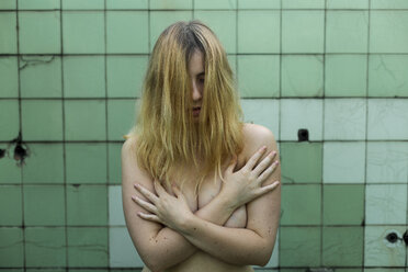 Nude woman showing emotions in bathroom, feminism, abuse and violence against women - FMGF00003