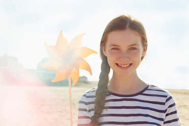 Girl with pinwheel on seaside holiday - CUF43909