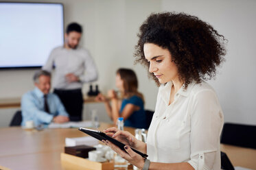 Businesswoman in office using digital tablet - CUF44015