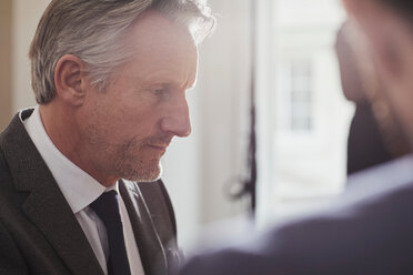 Businessman in office talking to colleague - CUF44031