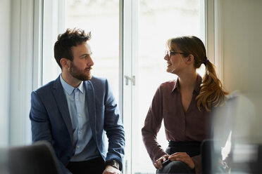 Colleagues chatting in office - CUF44034