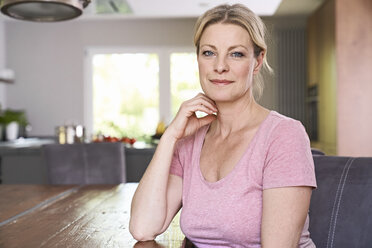 Portrait of confident woman sitting at table at home - PDF01756