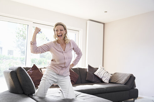 Portrait of exuberant woman posing on couch at home - PDF01782