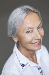 Portrait of smiling enior woman with grey hair and blue eyes - VGF00016