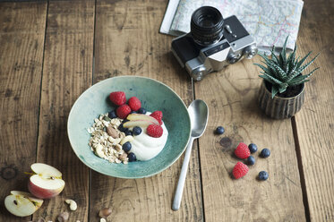 Breakfast bowl with granola, yogurt, nuts, apple, raspberry, blueberry on wood - ASF06236