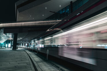 Electric railway train passing by DOKK1 public building, Aarhus, Midtjylland, Denmark - CUF44221