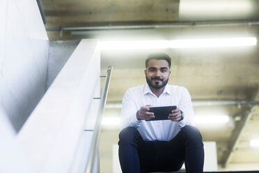 Young man using digital tablet in office - CUF44239