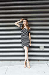 Portrait of young woman wearing striped dress - GIOF04581