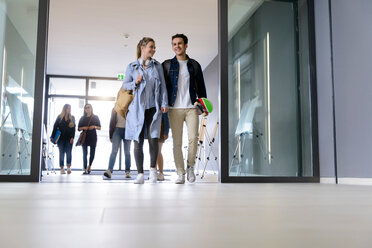 Students entering college building by glass doors - CUF44346