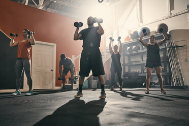 Man using dumbbells in gym - CUF44371