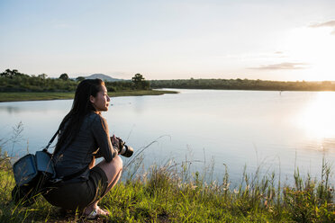 Junge Touristin mit Blick auf einen Fluss im Krüger-Nationalpark, Südafrika - CUF44395