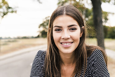 Portrait of smiling young woman outdoors - UUF15442