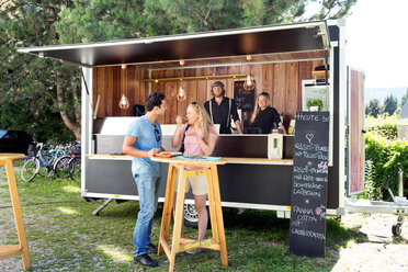 Customers enjoying meal at food truck, Innsbruck Tirol, Austria - CUF44444