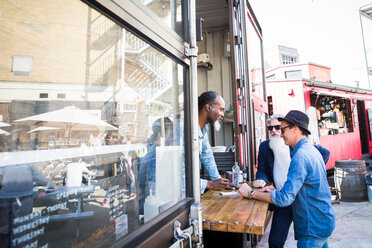 Vendor taking food orders from customer - CUF44470