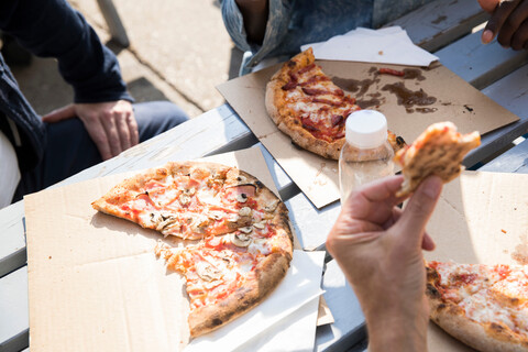 Freunde essen Pizza im Freien, lizenzfreies Stockfoto