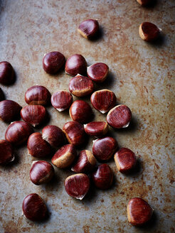 Chestnuts on rustic surface, close-up - CUF44582