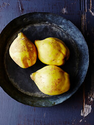 Still life of three quinces in metal pan, overhead view - CUF44591