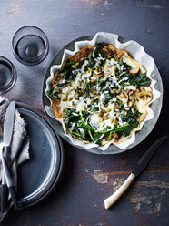 Still life with bowl of spinach feta mushroom frittata, overhead view - CUF44634