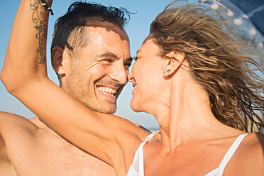 Mature couple on beach, face to face, smiling - CUF44746