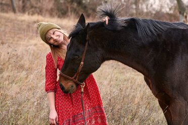 Portrait of woman with horse smiling - CUF44763