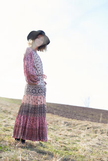 Frau im Hippie-Stil mit Filzhut auf einem Feld, Porträt - CUF44781