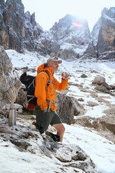 Hiker having warm drink, Canazei, Trentino-Alto Adige, Italy - CUF44968