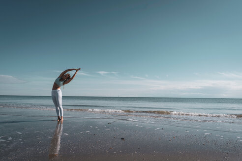 Frau übt Yoga am Strand - CUF44997