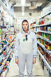 Portrait of woman wearing adult bodysuit in supermarket isle, looking at camera - CUF45136