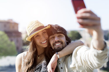 Porträt eines glücklichen jungen Paares, das ein Selfie mit einem Smartphone macht - GIOF04694