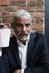 Portrait of bearded senior businessman with coffee to go - IGGF00644