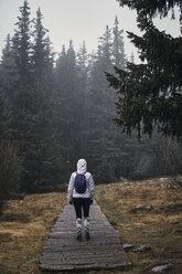 Bulgaria, Young yoman walking through the forest, rainy weather - BZF00465