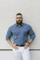 Portrait of bearded hipster businessman wearing glasses and plaid shirt - FMGF00012