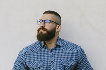 Portrait of bearded hipster businessman wearing glasses and plaid shirt - FMGF00013