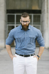 Portrait of bearded hipster businessman wearing glasses and plaid shirt - FMGF00032