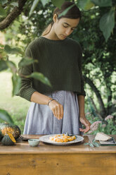 Young woman with homemade pumpkin gnocchi - ALBF00617