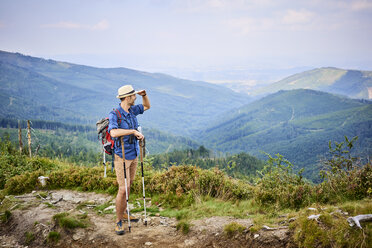 Man admiring the mountain view during hiking trip - BSZF00702