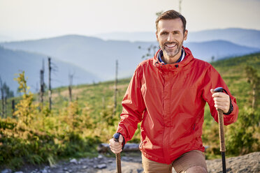 Portrait of smiling man hiking in the mountains stock photo