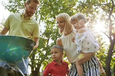 Family having a barbecue in garden - ZEDF01593