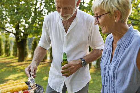 Älteres Paar beim Grillen im Garten - ZEDF01595