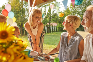 Happy extended family having a garden party - ZEDF01609