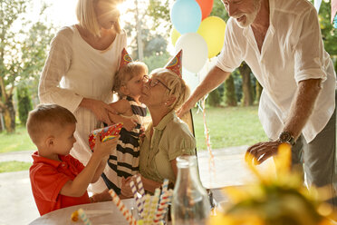 Happy extended family on a garden birthday party - ZEDF01666