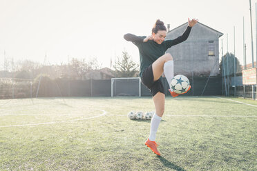 Football player practising on football pitch - CUF45229