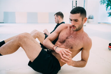 Man doing abdominal exercises - CUF45248