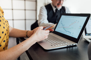 Woman using smartphone and laptop - CUF45266