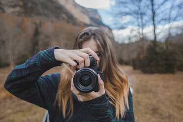 Spain, young woman with camera in Ordesa National Park - AFVF01640
