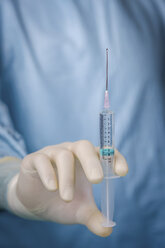 Close up surgeon holding syringe - FSIF03228