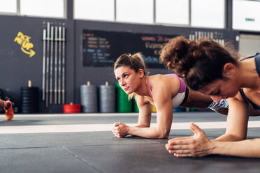 Beschnittene Ansicht von Frauen im Fitnessstudio beim Planking - CUF45582