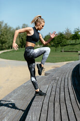 Young woman exercising on steps - CUF45631