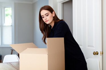 Woman with cardboard boxes packaging - CUF45697