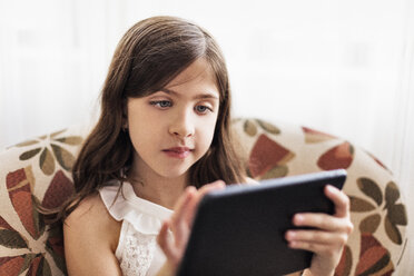 Girl using digital tablet on sofa - CUF45820